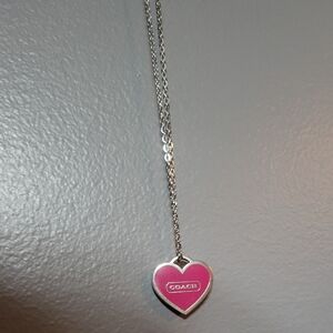 Coach pink heart charm on an unbranded silver necklace